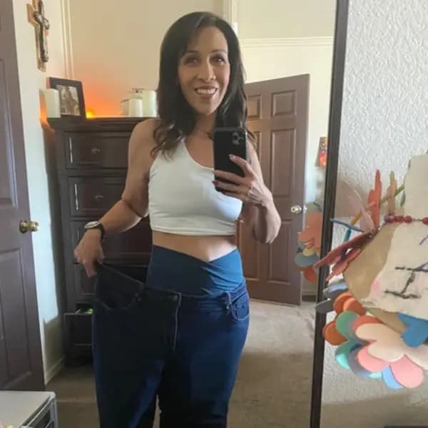 Patient showing old jeans after weight loss